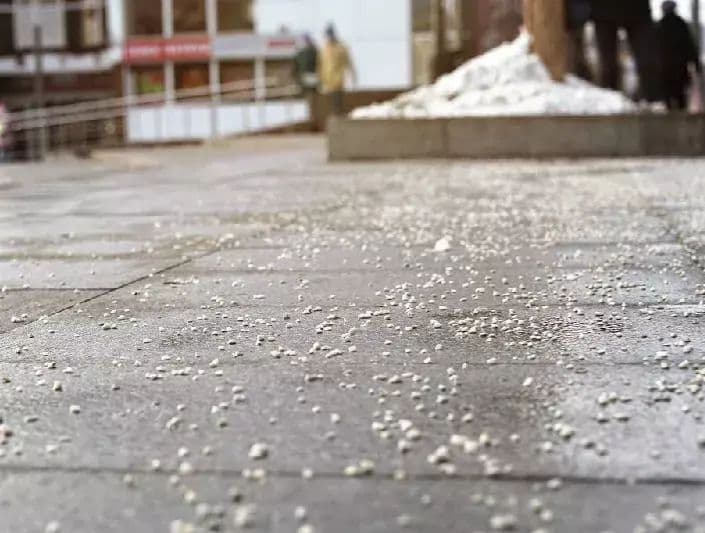 an image of snow salt scattered on the pavement